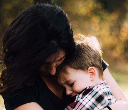 감정 조절: 스트레스와 불안을 극복하는 법 woman hugging boy on her lap