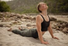 스트레스 해소와 건강을 위한 필라테스 동작 a woman is doing yoga on the beach