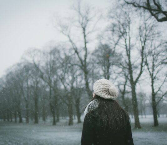 고혈압 관리를 위한 하루 10분 운동 woman wearing cap and black coat standing near bare tree