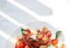 바쁜 일상 속 식단, 어떻게 균형 잡을까? 건강한 식습관 실천법 sliced tomato and green leaf vegetable on white ceramic plate