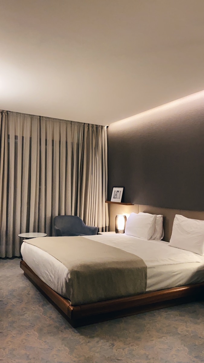 Photo by Linus Mimietz white bed with gray pillow